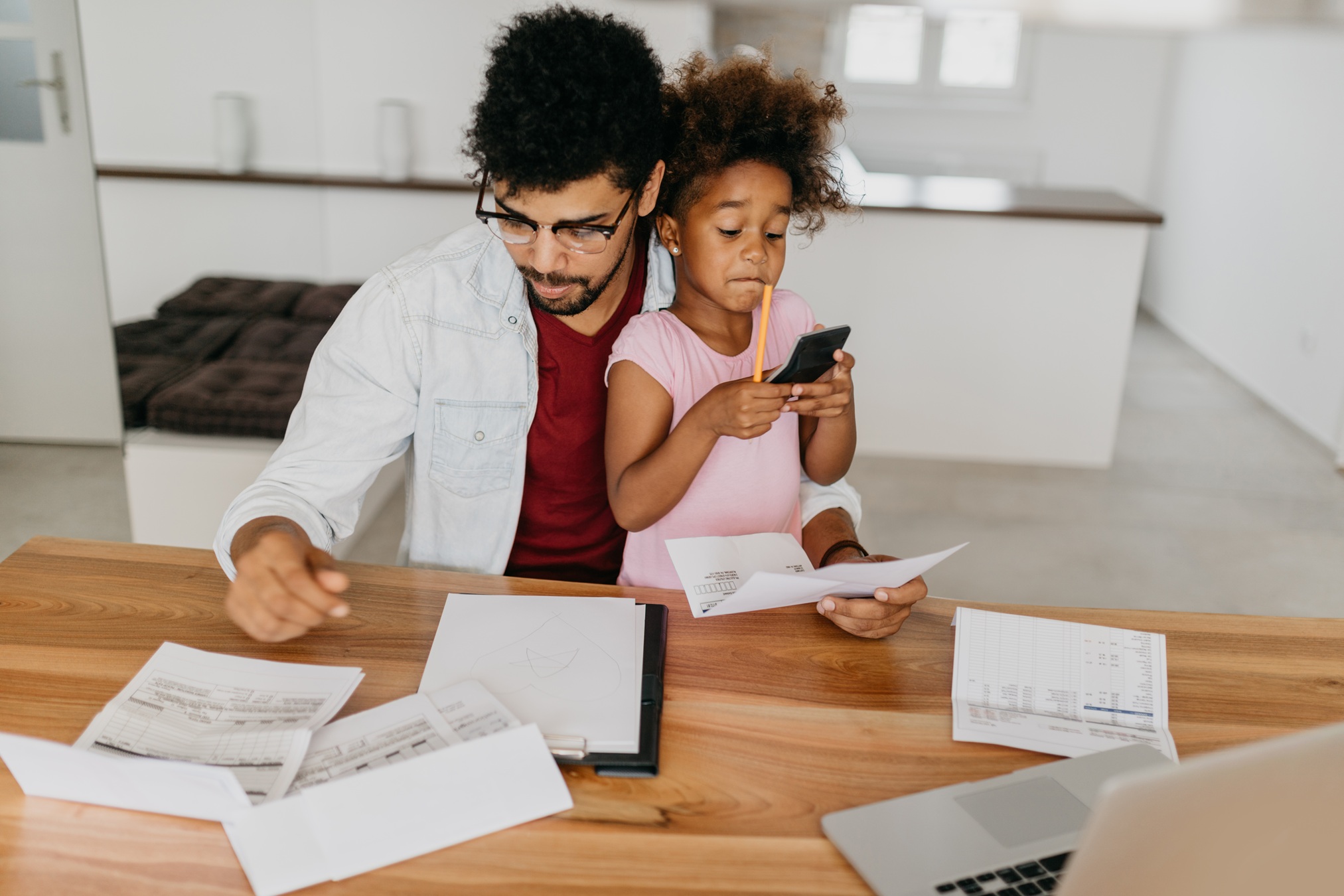 man with child doing paperwork