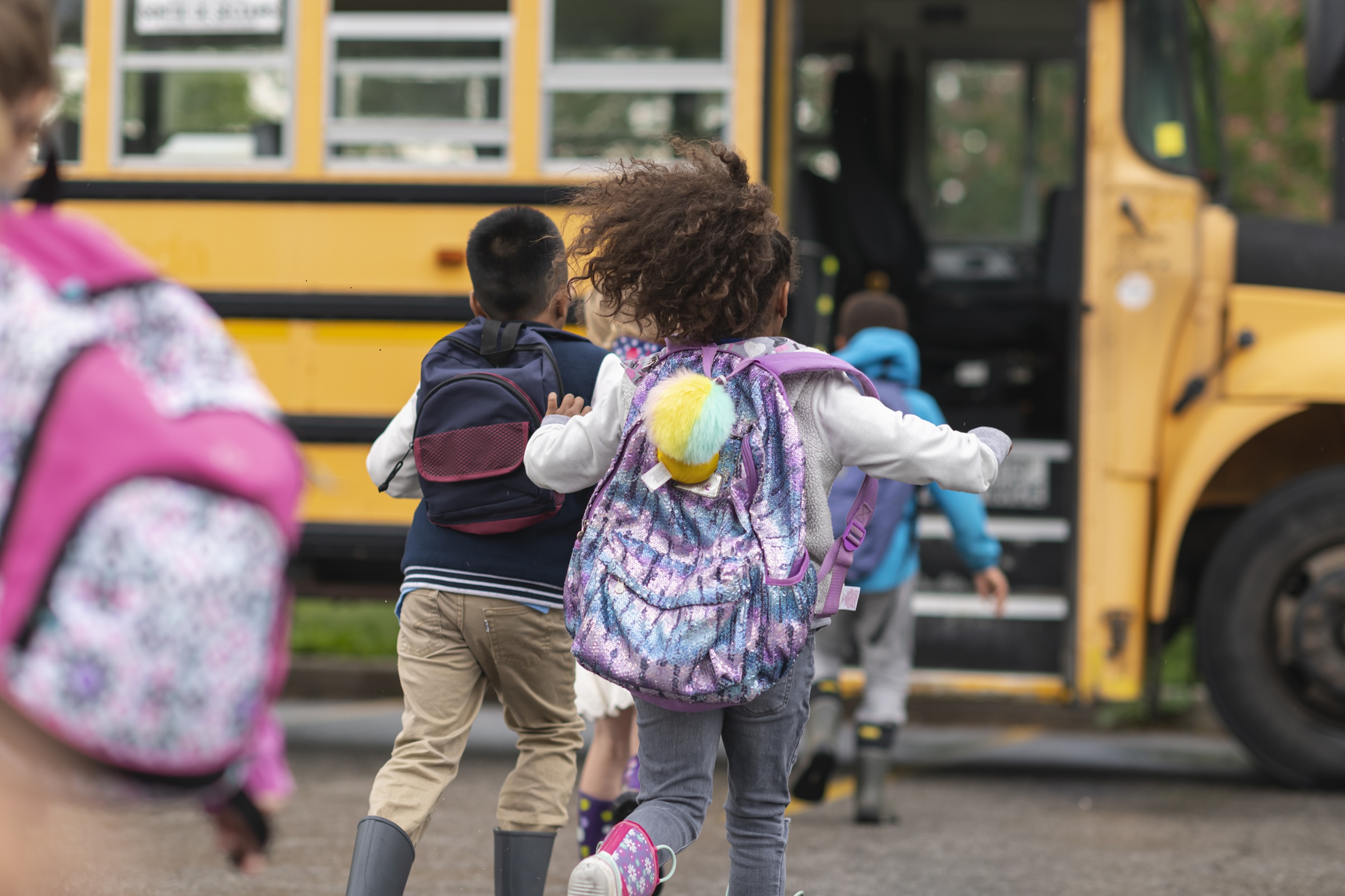 Girl running for bus with backpack